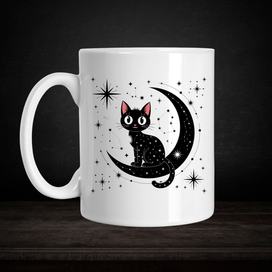 White mug with a black cat on a crescent moon design against a dark background