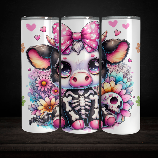 Colorful tumbler with a cartoon cow design featuring flowers and hearts on a black background.
